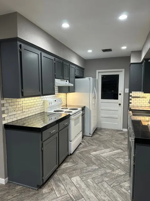Before: Slate cabinets and dark countertops.