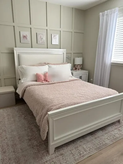 Bedroom with a new paneled accent wall behind the bed