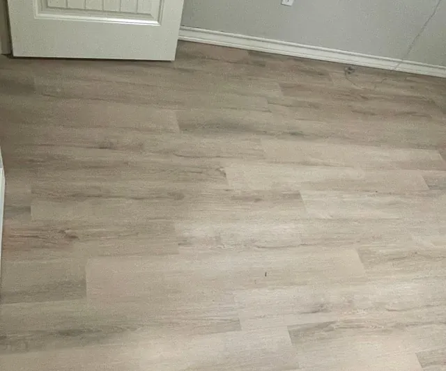 New wood-look vinyl plank floor in a bedroom